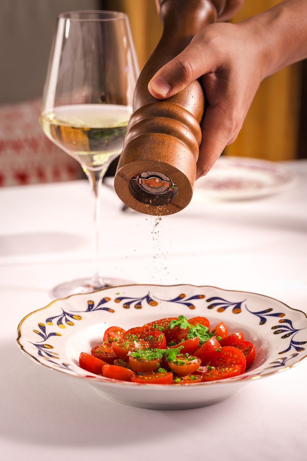 A glass of white wine and the tomato salad at ETNA