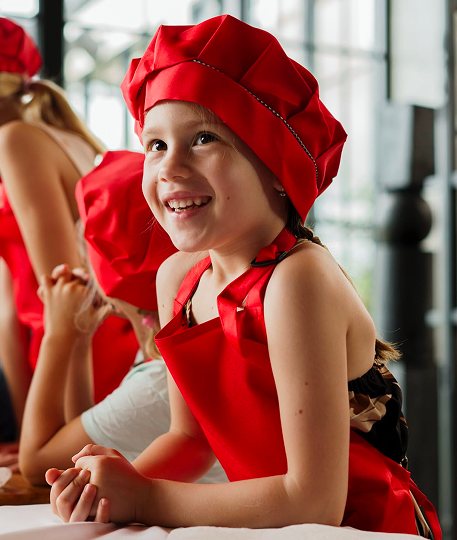 Kids cooking class in red chef hats