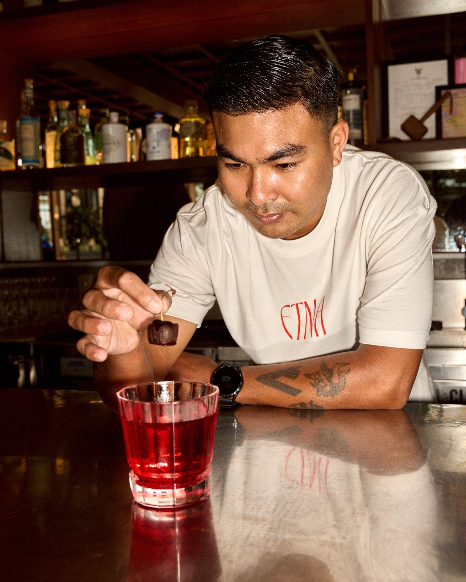 ETNA bartender garnishing a Negroni